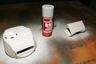 I use MR RESIN primer. I learned from preparing resin parts in my static kits that paint can often choose to leave the surface of a model at odd moments.  This provides a good surface.