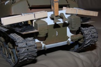The rear plate gets a homemade styrene filler plate to give the plastic a better surface to attach to.  Very thin card stock was used and my liberal use of MEK welded them in place.  I borrowed some tow hook brackets from my Perhing parts box.