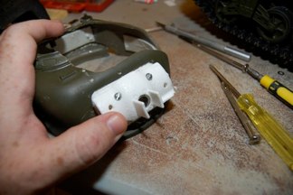 Screws directly into the PVC, Adjustable, and removeable.  Metal tube allows for the gun recoil.