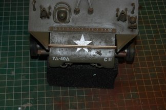 Standard Tamiya decals with a layer of Micro Sol to soften the film over the texture of the vehicle.  Unit markings added to front bumper.