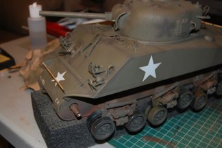 Using Tamiya Khaki Drab, I begin to shade the Lines and mask the Turret star.  A common camoflage was to obscure the large and painfully obvious stars.