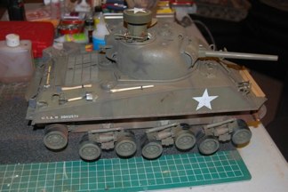 I use Tamiya earth to add mud stains to the lower hull.