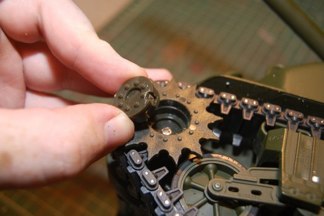 The sprocket was engineered to come off.  Just a twist and a pull (I used a small flathead screwdriver to help.