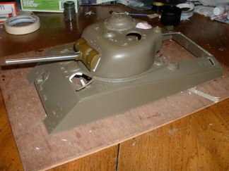 The Project has begun with the modification of a spare Tamiya 105mm howitzer turret and a replacement hull ordered from the Tamiya website.  My spares box donated a Pershing commander’s cupola, Sherman 105mm elevation components, crew hatches, and machine guns.