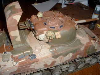You can see a before and after look in the pictures below.  After the initial washes were dry I applied a dull coat to the vehicle and the applied a layer of black soot to simulate the “Sands of Iwo Jima”.