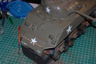 Tamiya clear lacquer sprayed on key areas and Tamiya decals placed on tank.  I decided to start with the entire spread and work my way back down to field look.