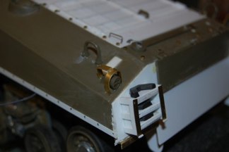 Mounted to the rear above the tamiya light assembly.  I added some rubber chevrons to the track stowage and added some hinges to the retainer.