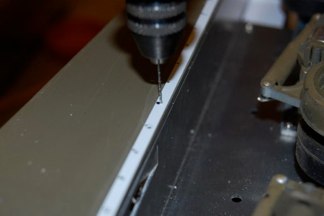 after measuring the correct distances i use a motor tool and microbit to make the holes.