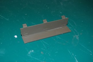 Later Shermans came with a folding stowage rack that attached to the rear of the engine deck.  Tamiya has a one piece rack with the folding arms extended.