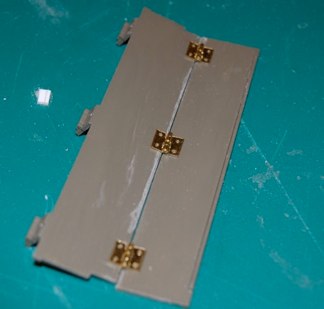 I affixed some brass hinges and actually used the brass tacks to connect it.