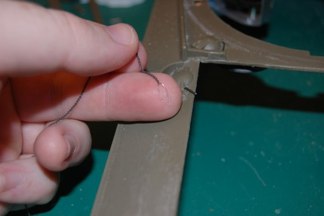 I use Steel Wire and small scale chain to make the retainers.  Thread the wire through the link and twist to make an eyelet.