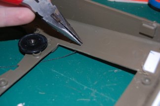 I push the wire through the hull and bend it over to keep it in place.  A drop of CA helps.