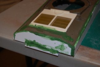 Photo etch grilles placed, squadron green putty liberally applied to hull areas to fill in weld seams.