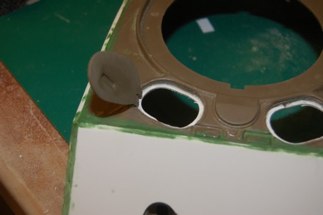 To support the hatch I glued styrene to the hull and created the lip by grinding out the oval.