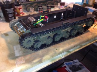 I bolted the trucks back on.  This time around I prime the hull entirely in Black and sprayed the outer hull in OD Camo from Krylon.