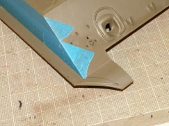 Using a razor saw, motor tool, and files I removed the molded on mud guards off of each side of the upper hull. Then using .020 styrene I fabricated the attachment bars along the bottom edges of the upper hull. The pictures below show the before and after shots of that modification