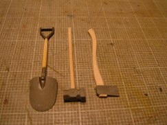 Once the handles were the desired shape and size I reworked all of the plastic parts that needed modifying. The axe head for example, is not molded to show the wooden handle passing through the metal axe head, so I drilled mine out so that the new wooden handle passes through the axe head just like on it's life size counter part.