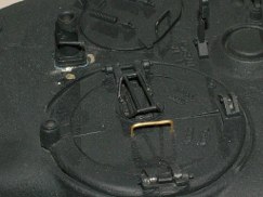 Plus I had neglected to modify the stock machine gun mount. On the Tamiya kit the machine gun mount for the top of the turret is made with a three legged raised design made to go over the the top of the ventilator. Well if you recall the 75mm doesn't have the extra ventilator, so it was removed (filled and puttied), so obviously the machine gun could now be secured flush to the turret top with a mounting plate. The first picture show the unmodified stock part, and the second picture shows it with the "tri-pod" legs ground off