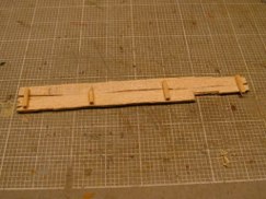 I started by making two pieces of 90 degree angle stock out of .125 X .030 styrene strip cut to .400 in length. The strip was glued at right angles using MEK solvent, and then added to the bottom edge of the inside lip of the front fenders.