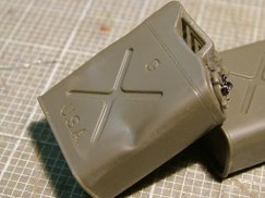 Following Ethan's lead, I added a retaining chain to hold the fuel filler cap on the jerry cans. I drilled out each of the caps for the 5 gallon fuel cans with a .020" micro drill bit in my pin vice. Then I used a small piece of .010" wire to make a retaining hoop to secure a piece model railroad chain through the center of the cap. I then drilled another hole in the center of the fuel can before I glued on the handle, and secured the opposite end of the retaining chain through a second hoop made from the same wire.