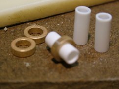 Well I took Jeff's idea and applied my poor man approach to solve the same problem. I had purchased and installed wheel bearings when I did the suspension, so I had a baggie containing the stock wheel collets. I also had some styrene tubing of the appropriate diameter.