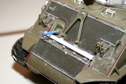 The frontal armor is detailed with bolts that actually hold it together.  It is attached Lightly with C.A. so it can come off.