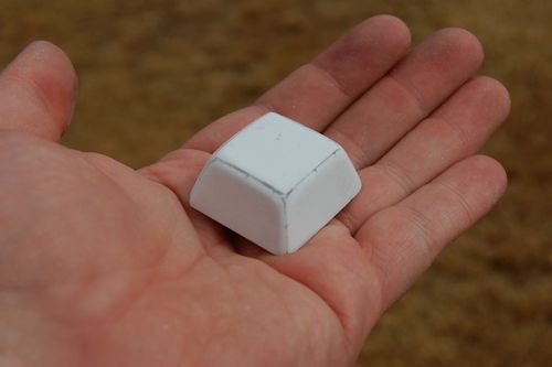 Sheet styrene was cut into a trapezoid and filled with super glue for the conning tower. A Dremel tool rounded the corners and ground it down to the approximate shape.