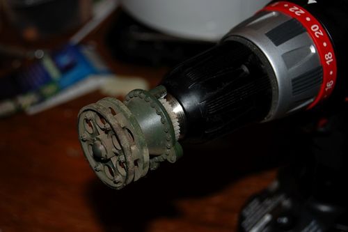 After a few attempts with pliers, I simply chucked it into my cordless drill and unscrewed it.  It came right off with no problems.