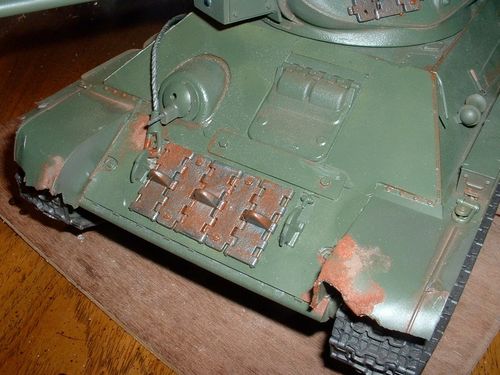 Rust is visible on most Russian equipment.  I started experimenting with baking soda and paint.  I have dented the fenders and stowage boxes for effect.  Every Soviet tank I have seen has had the living @#$% beaten out of it. The tracks were painted gunmetal.   Running outdoors will weather the suspension.