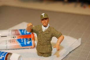 Painted uniform with acrylics.  Skin painted in acrylics and water colors.  I weathered the uniform just a bit too much but it will even out.