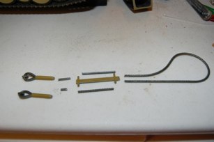 I cut apart the plastic tow cable to get the basic parts that real cable can fit to.  I bored out the ends with various drill bits and voila!