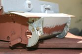 Front end mods include transmission brackets and metal tow hooks with the correct flat plate. Note the small screws used to attach the brass hinge!