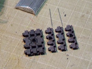The track links are molded in hard black plastic, have great detail, but do show some injector pin marks on the inside surface of each link. The one nice thing is that unlike the Tamiya King Tiger track, the metal pins are fully captured as they pass through each section of the link, meaning they appear to be better engineered and should prove to be stronger. Looks like Hooben has done their homework. The track went together relatively easily and without a hitch, took about 90 minutes to assemble both sides.